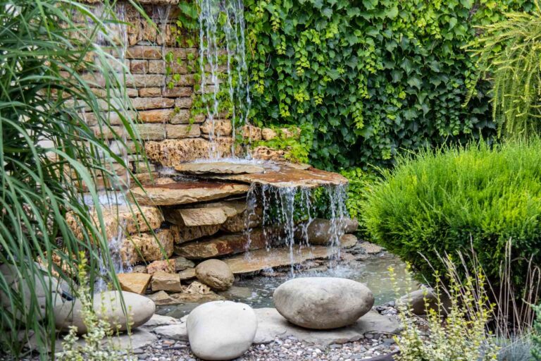 homeguide water fountain in a landscaped residential backyard